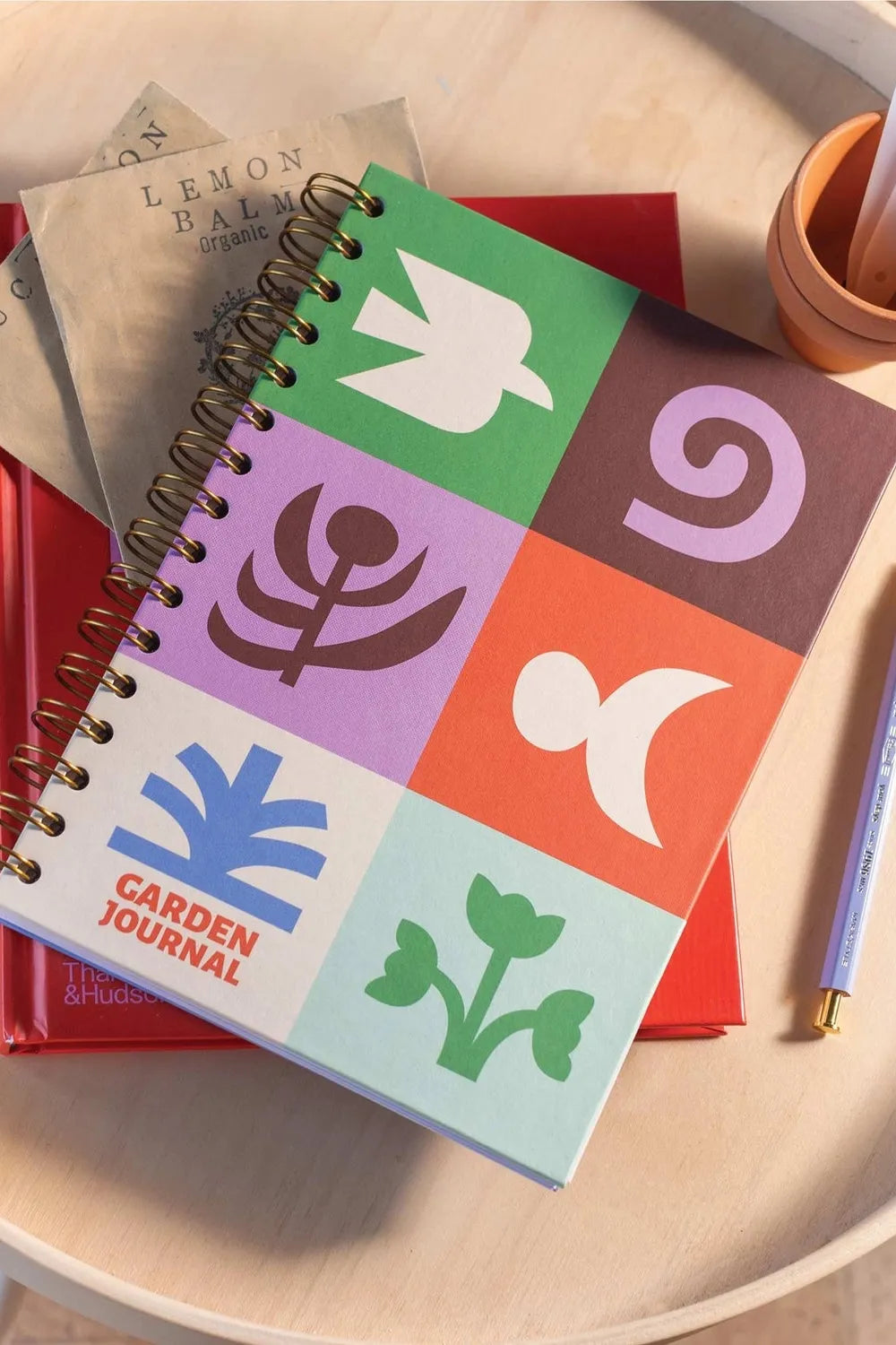 Garden journal with colourful geometric designs on a wooden surface