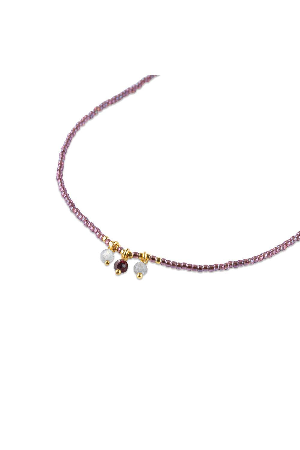 Necklace with purple and white beads on a white background