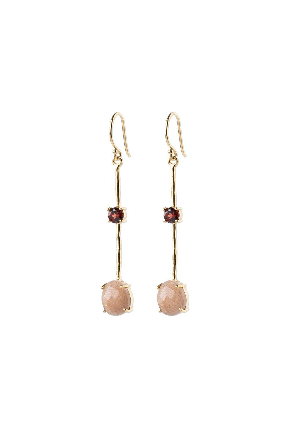Gold earrings with pink gemstones on a white background