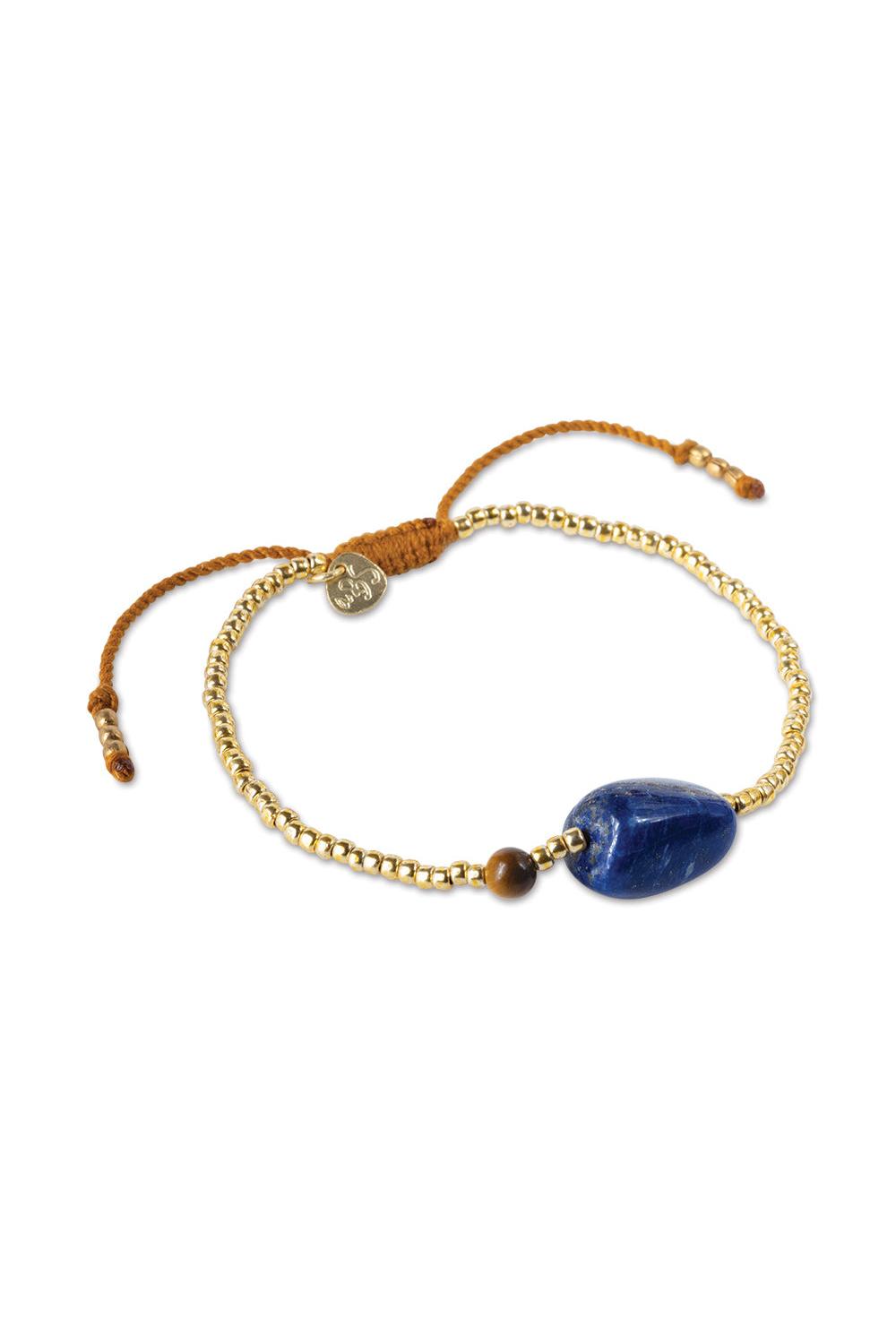 Bracelet with blue stone and gold chain on a white background