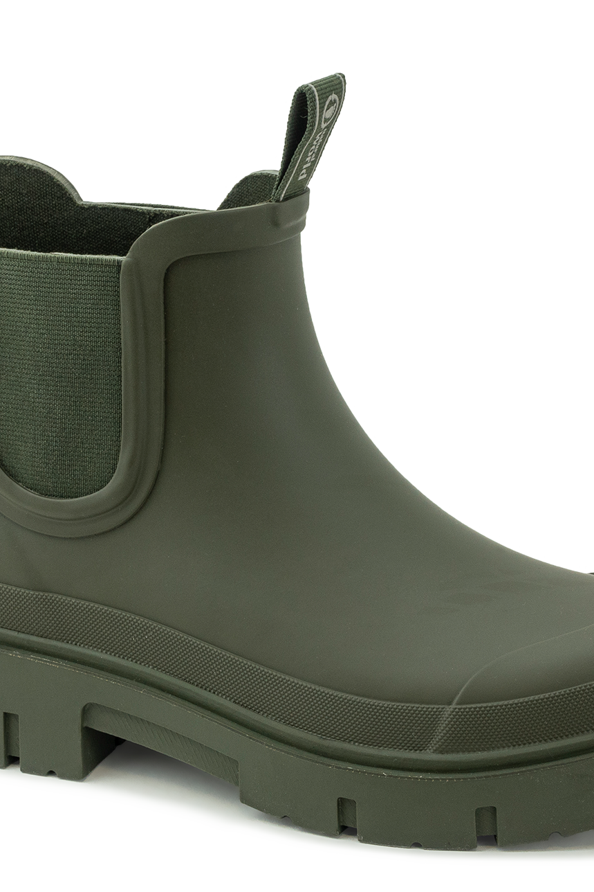 A black waterproof Natural World rubber Chelsea boot with a chunky lug sole against a plain background.