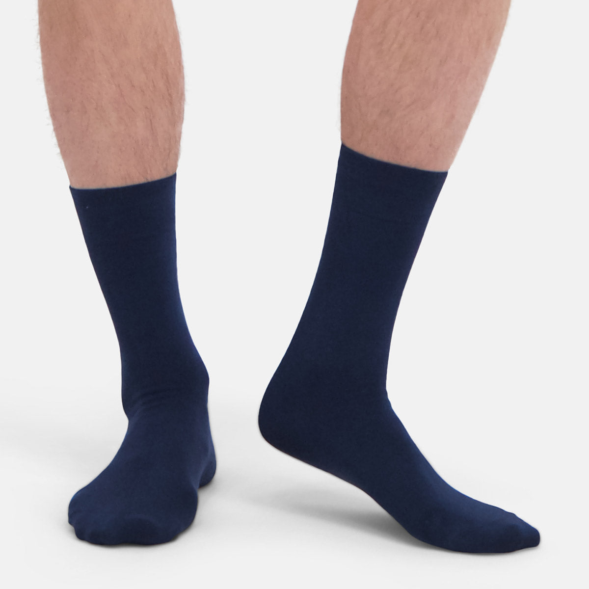 Navy blue bamboo socks worn by a person on a white background