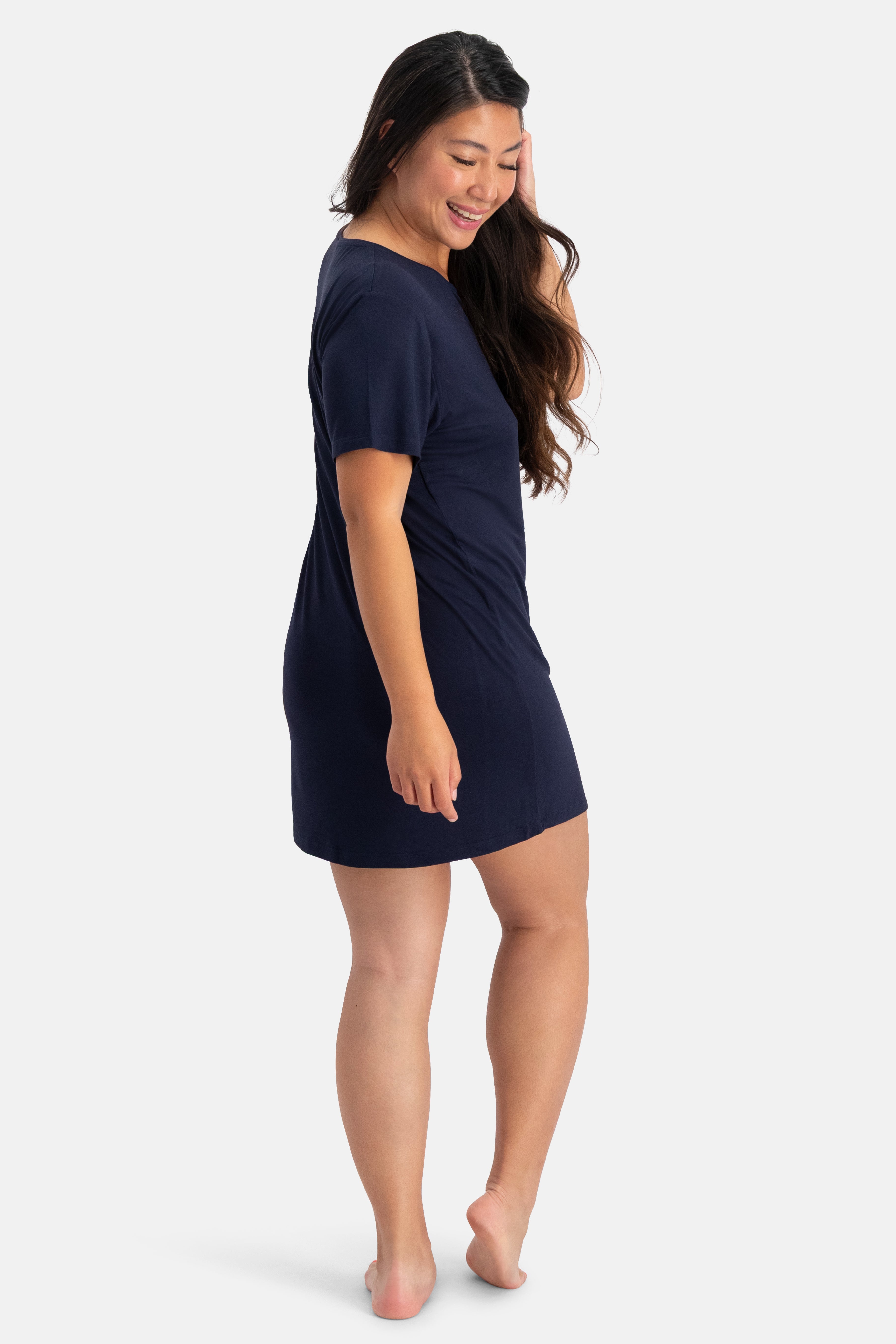 Woman wearing a navy blue bamboo nightie on a white background