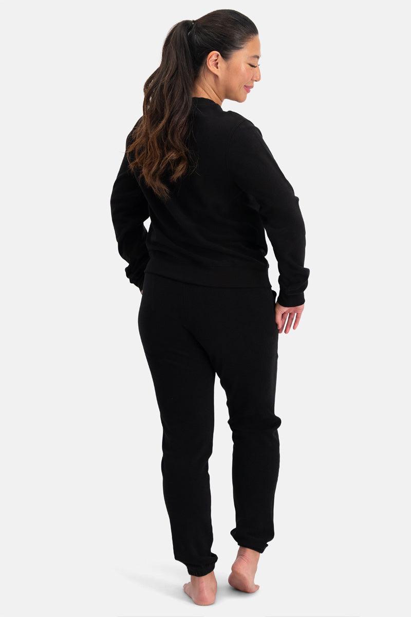 Woman wearing a black bamboo outfit on a white background