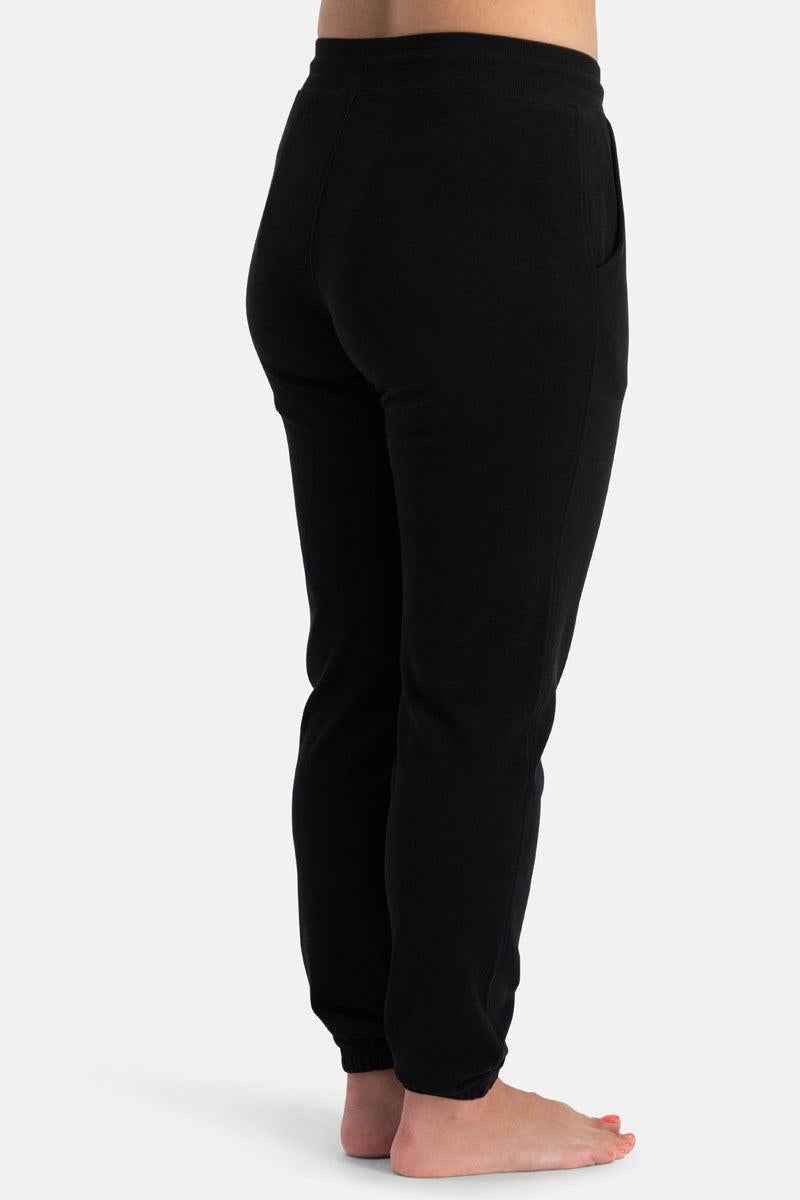 Black bamboo sweatpants worn by a person on a white background
