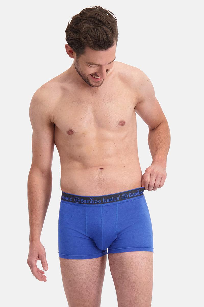 Man wearing blue boxer bamboo briefs on a white background