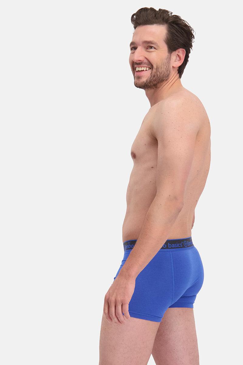 Man wearing blue bamboo underwear on a white background