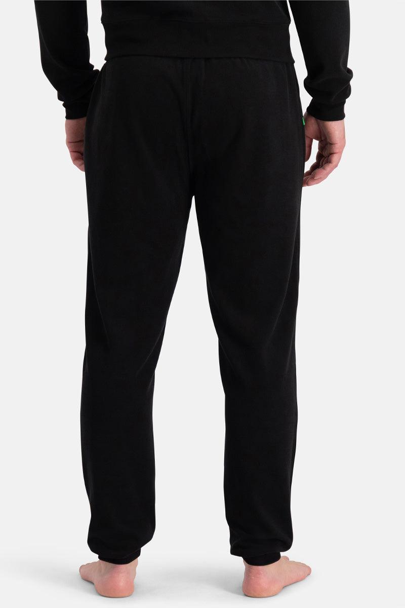 Black organic cotton sweatpants worn by a person on a white background