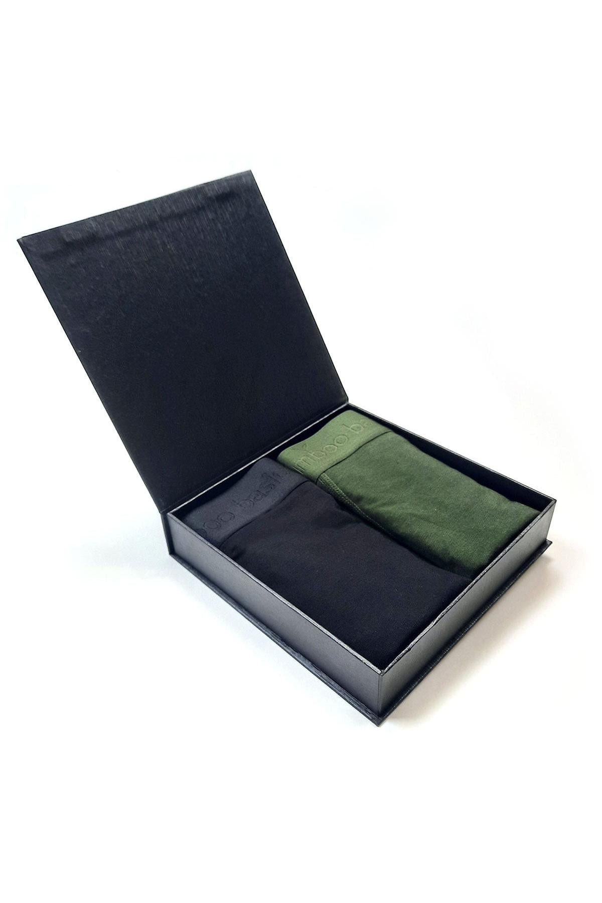 Black box with black and green bamboo boxers inside on a white background