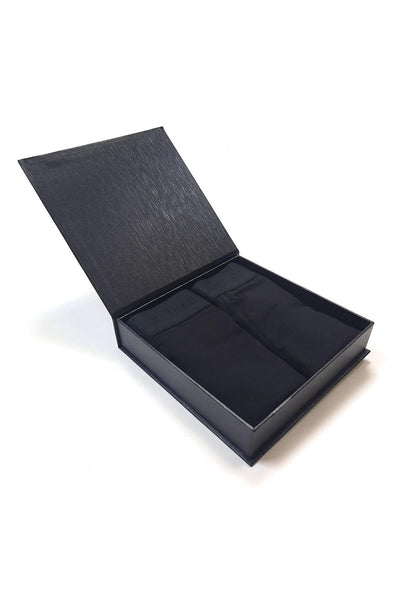 Black giftbox with a lid open with mens bamboo boxers on a white background