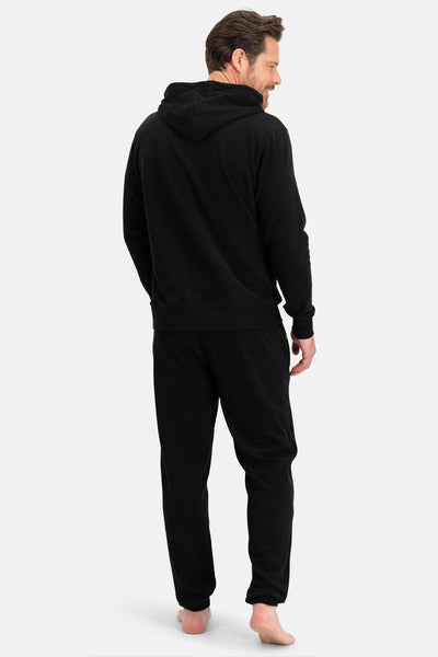 Man wearing a black bamboo hoodie and pants on a white background