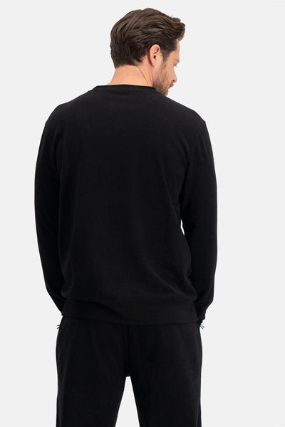 Man wearing a black long-sleeve bamboo shirt and pants on a white background