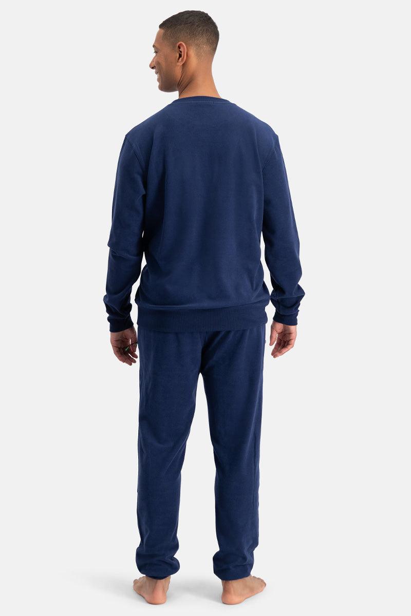 Man wearing a navy blue set on a white background