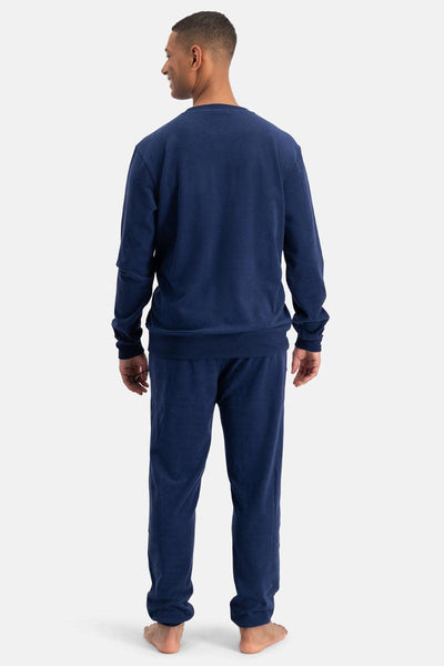 Man wearing a navy blue set on a white background