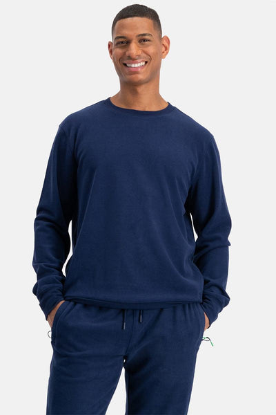Man wearing a navy blue bamboo sweatshirt and pants on a white background