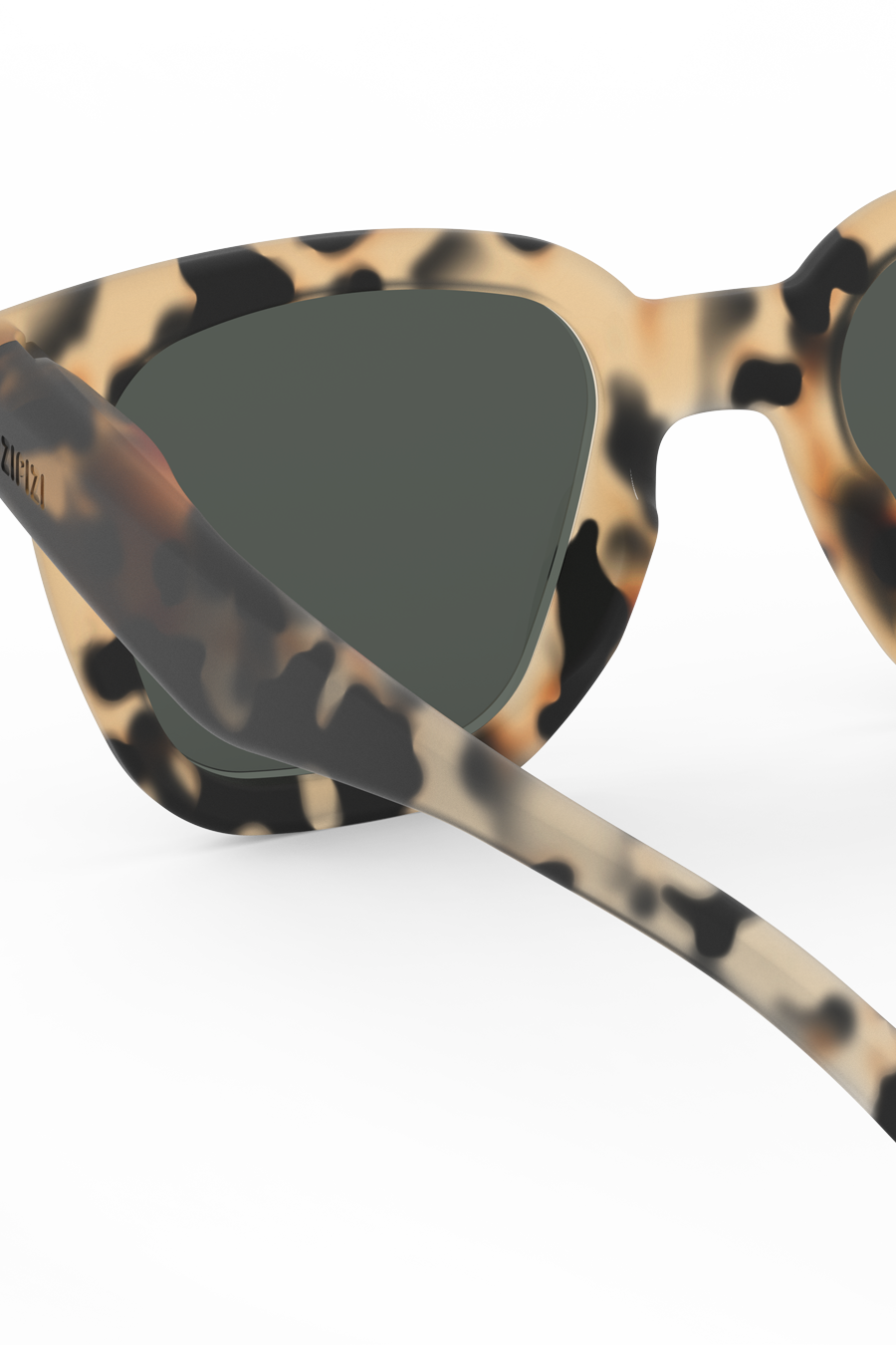 Light tortoise rectangular sunglasses shown at an angle highlighting soft beige and black tones.