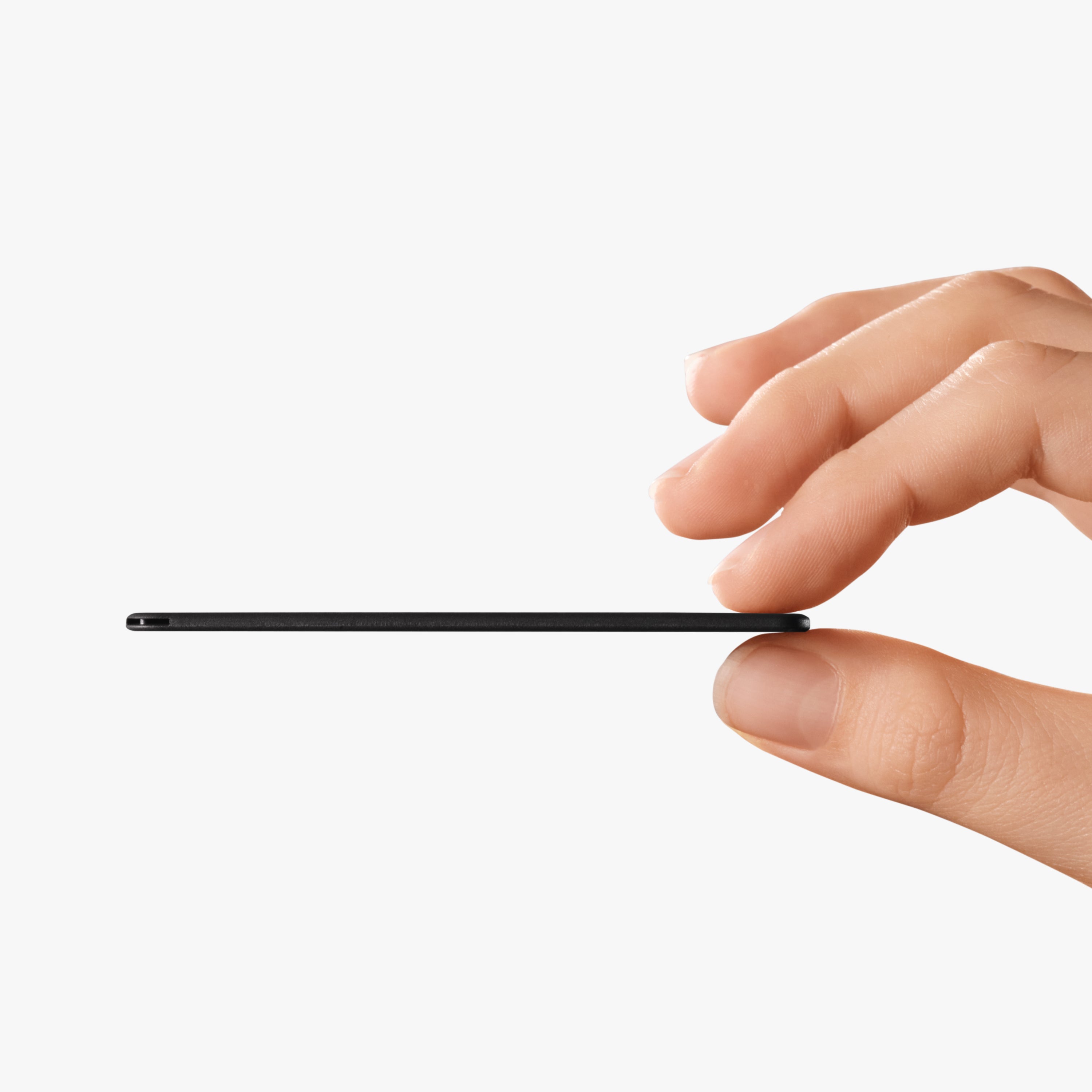Hand holding a thin black tracker device on a white background