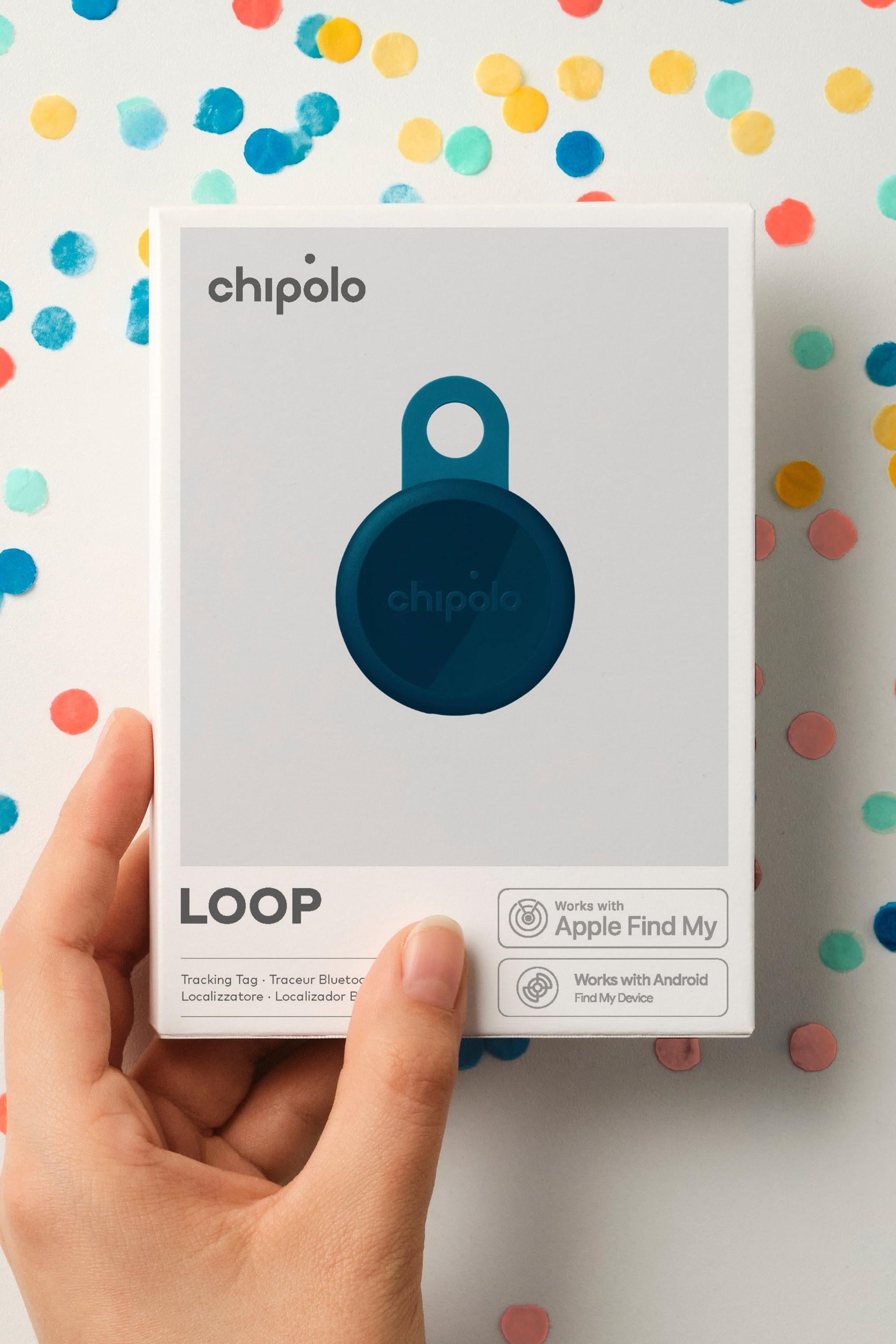 Hand holding a Chipolo Loop device packaging against a colorful polka dot background