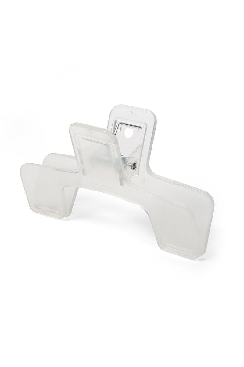 A clear plastic clip to keep a book open on the correct page