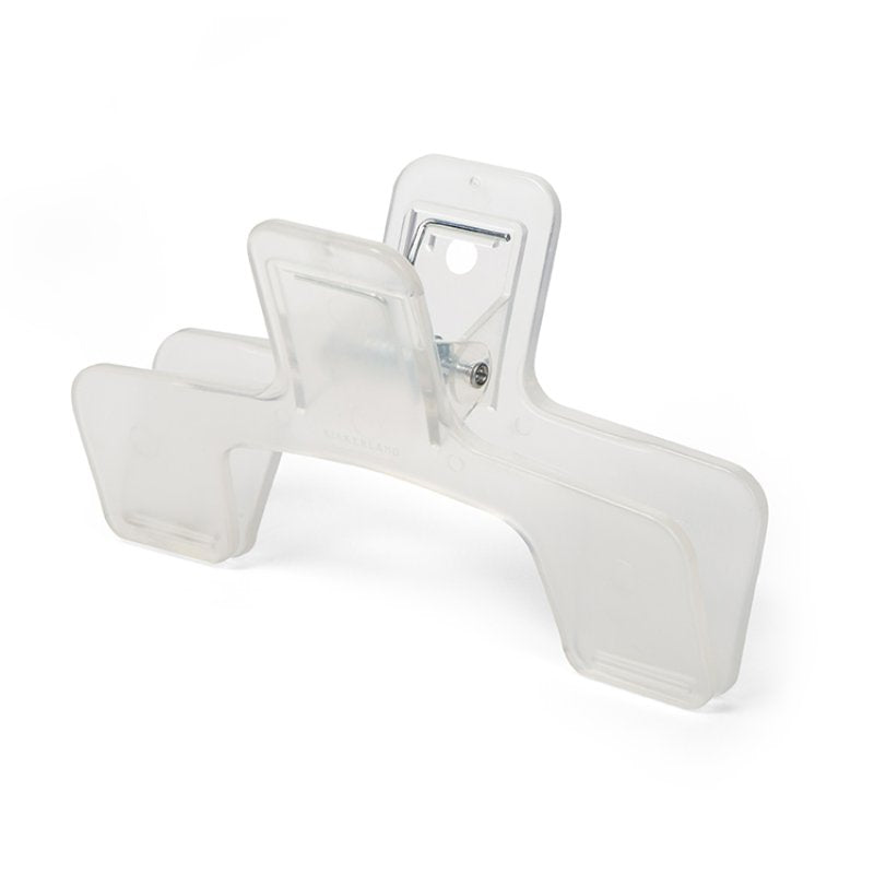 A clear plastic clip to keep a book open on the correct page