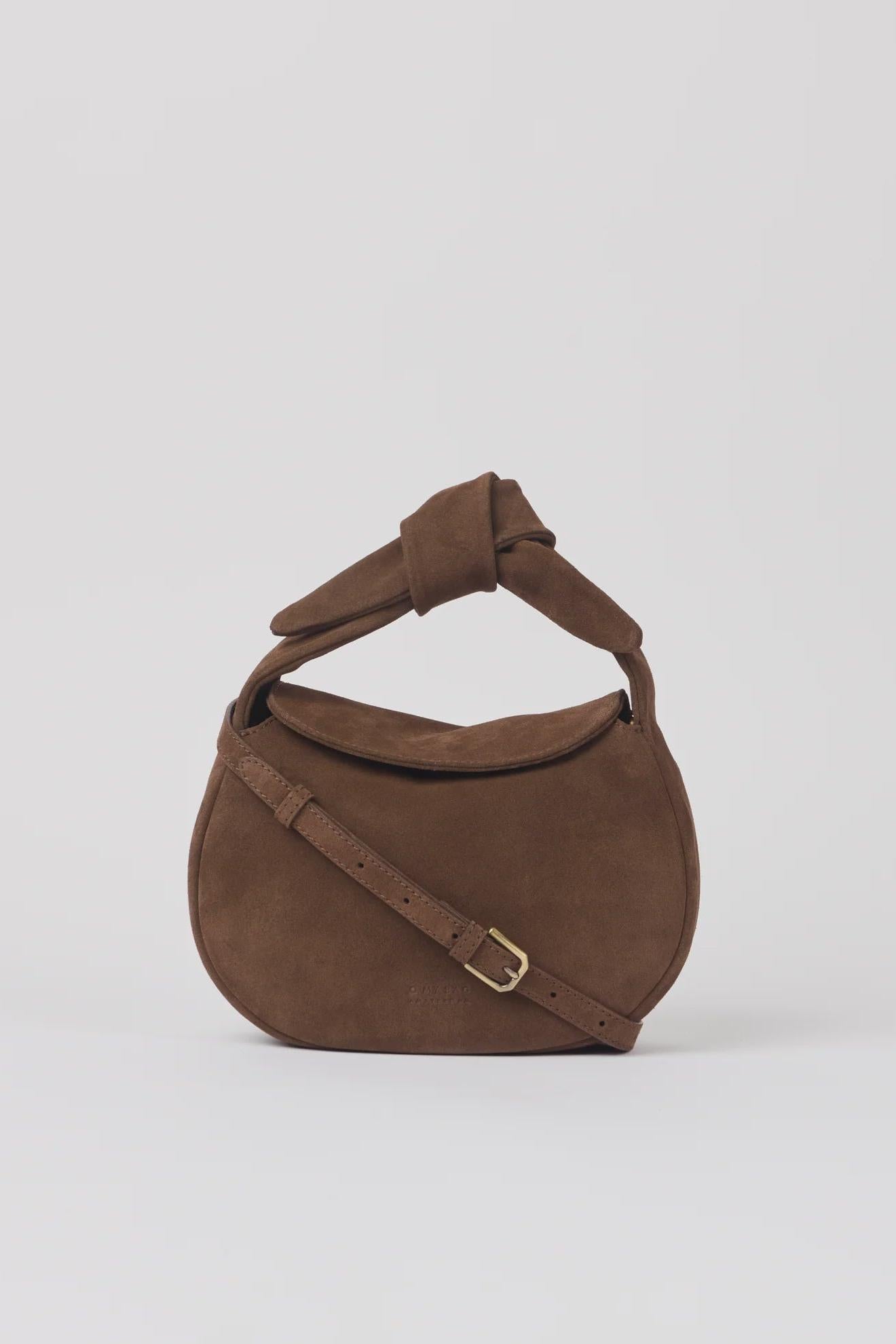 Brown handbag with a strap on a white background