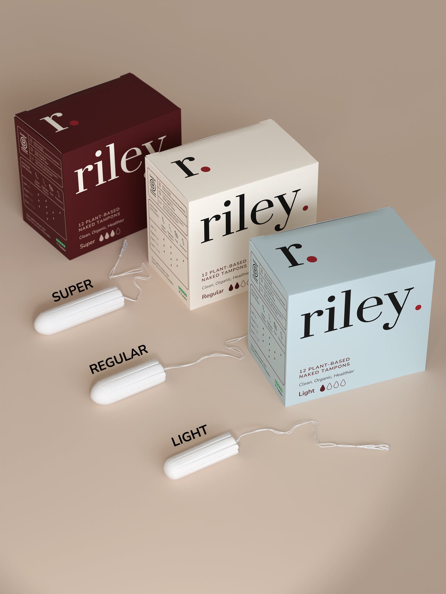 Three boxes of Riley tampons on a beige background
