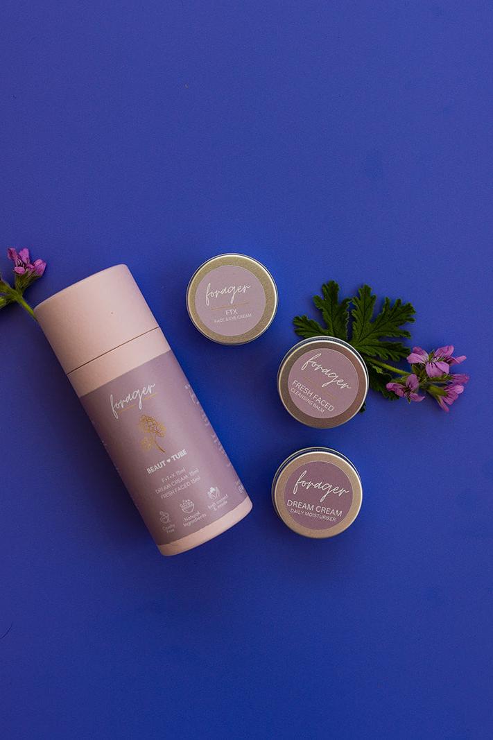 Cosmetic products with 'Forager' branding on a blue background