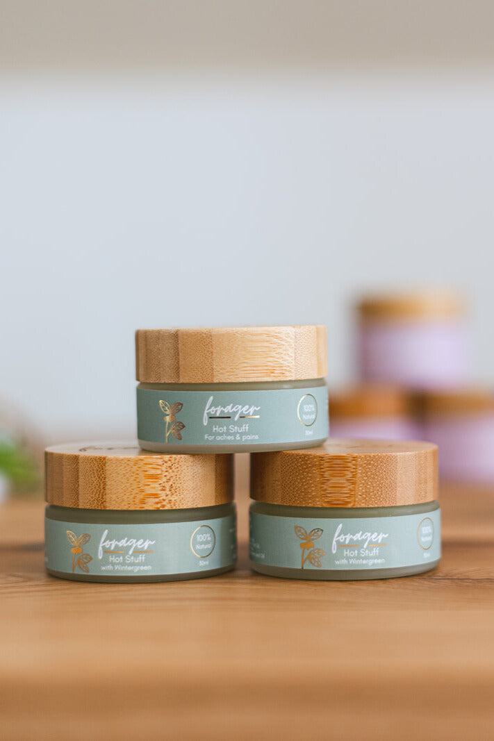 Three jars with wooden lids on a wooden surface