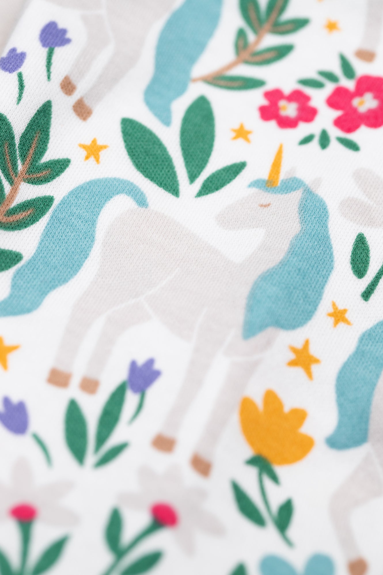 Organic cotton fabric with unicorn and floral pattern