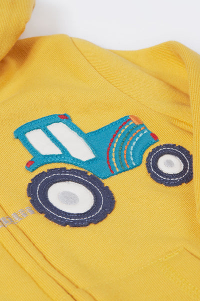 Close up of tractor applique detail on yellow organic cotton hoodie for kids