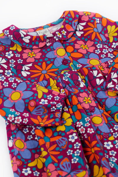 Colorful Frugi floral-patterned dress with a collar on a white background