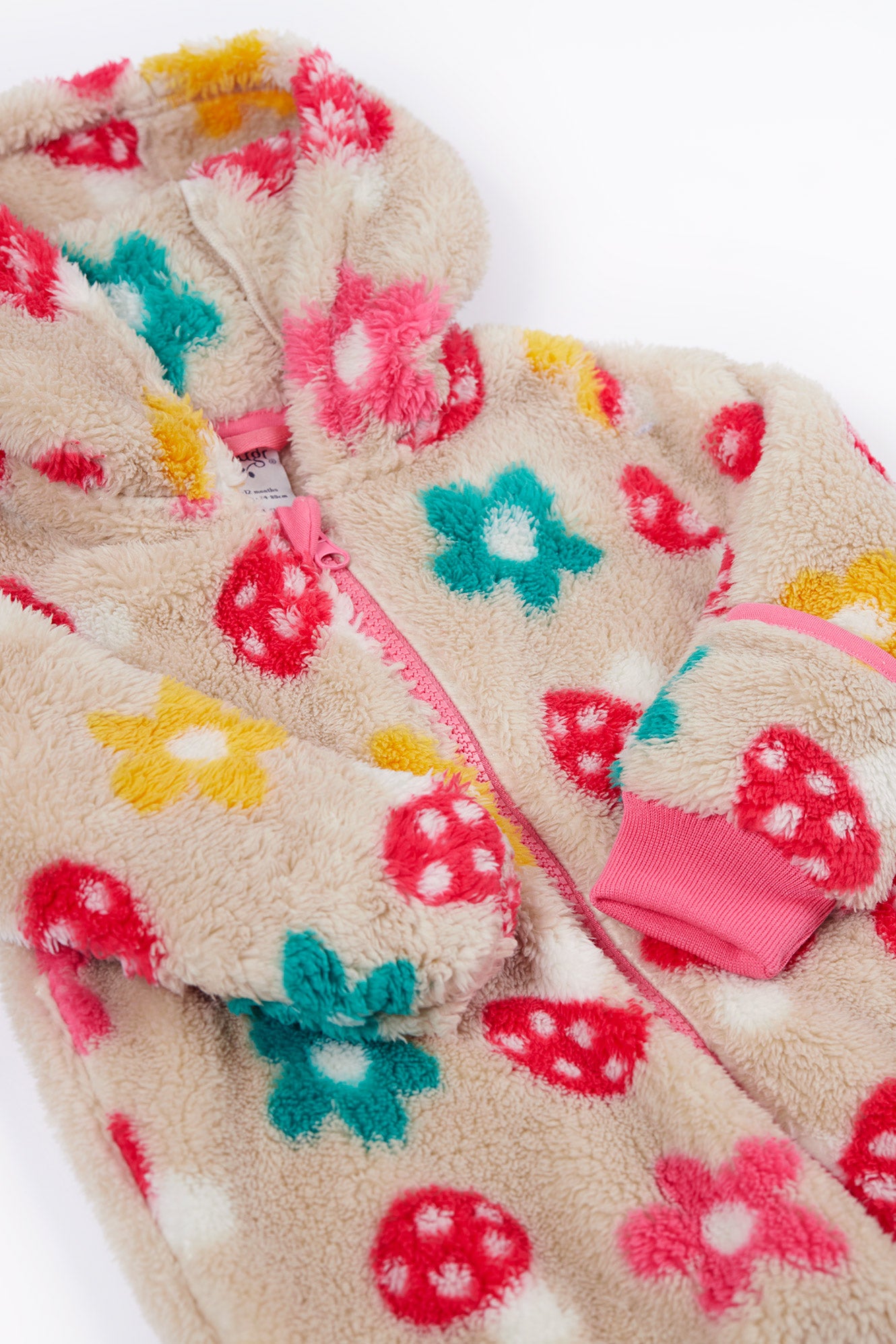 Floral-patterned fleece onesie with colorful flowers on a white background