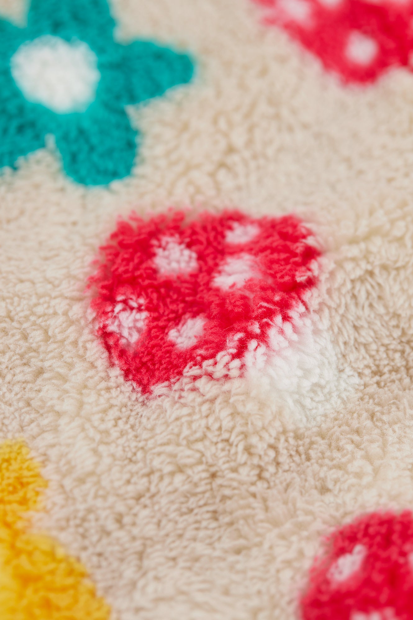 Close-up of a textured fabric with colorful flower patterns.