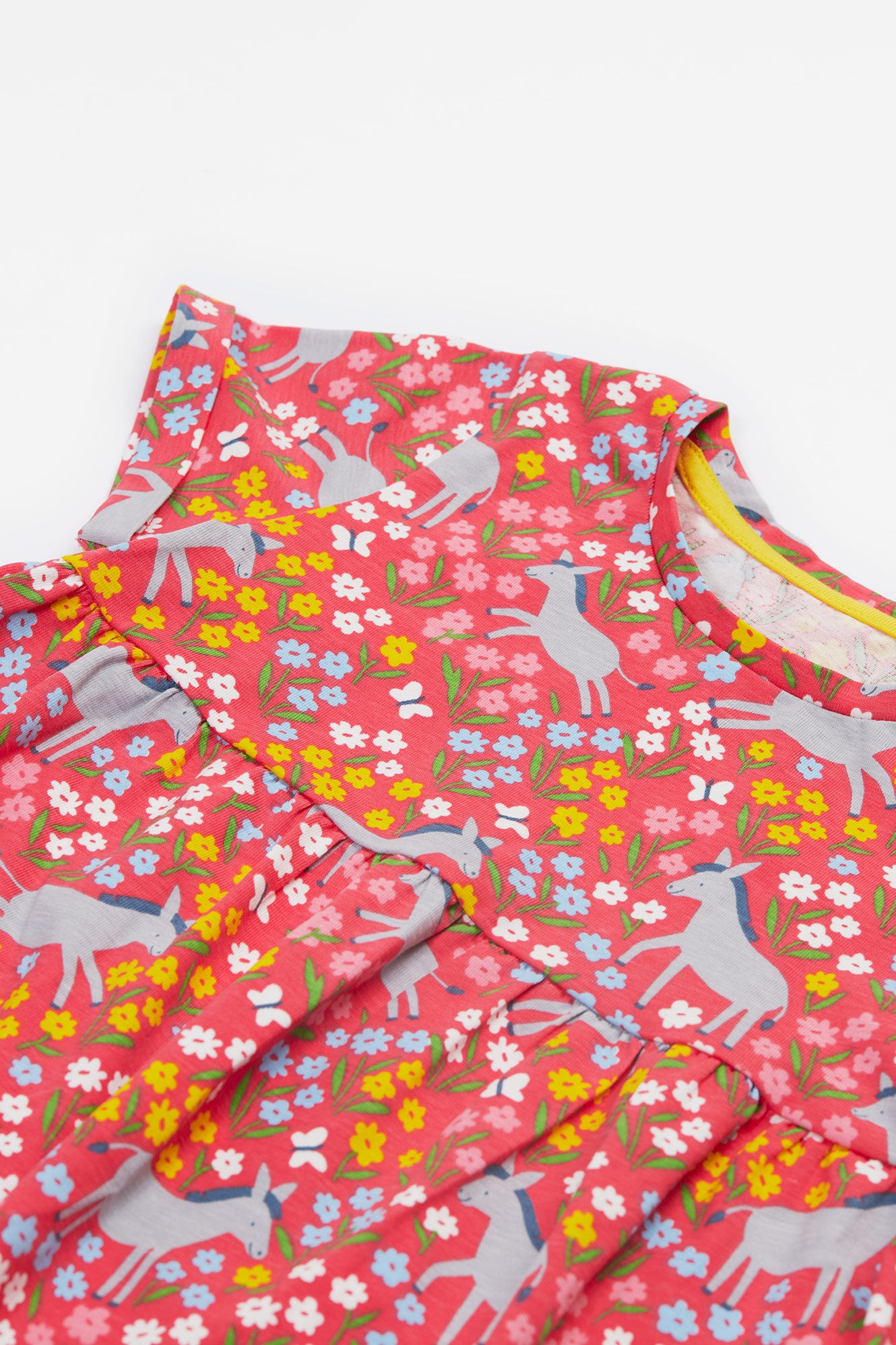Close-up of the organic cotton fabric featuring cheerful donkey themed print.