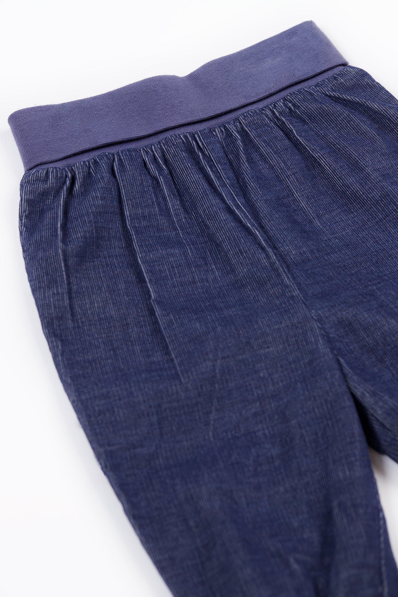 Blue organic cotton pants with a white background