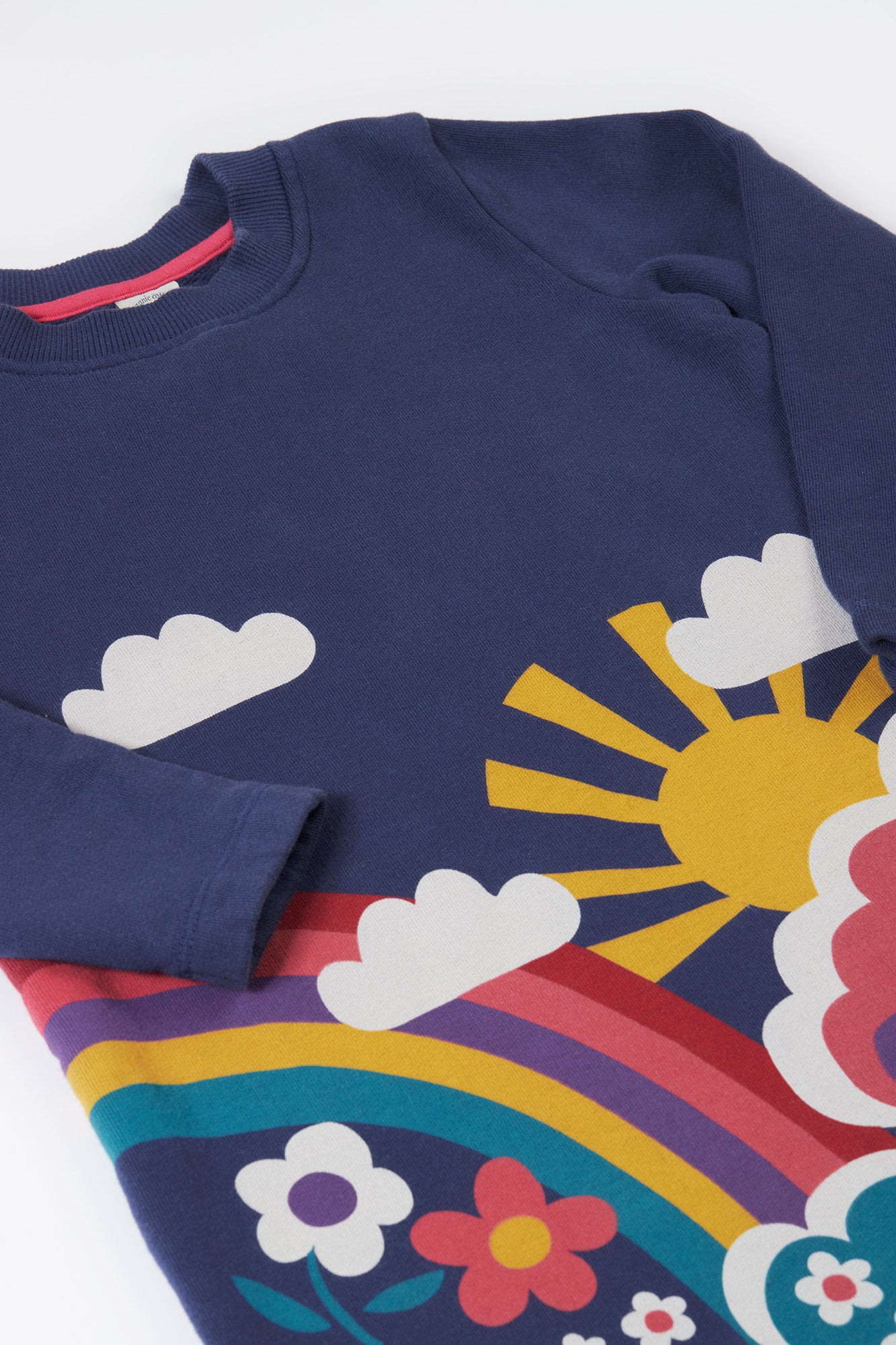 Navy blue sweatshirt with colorful sun, rainbow, and cloud design on a white background