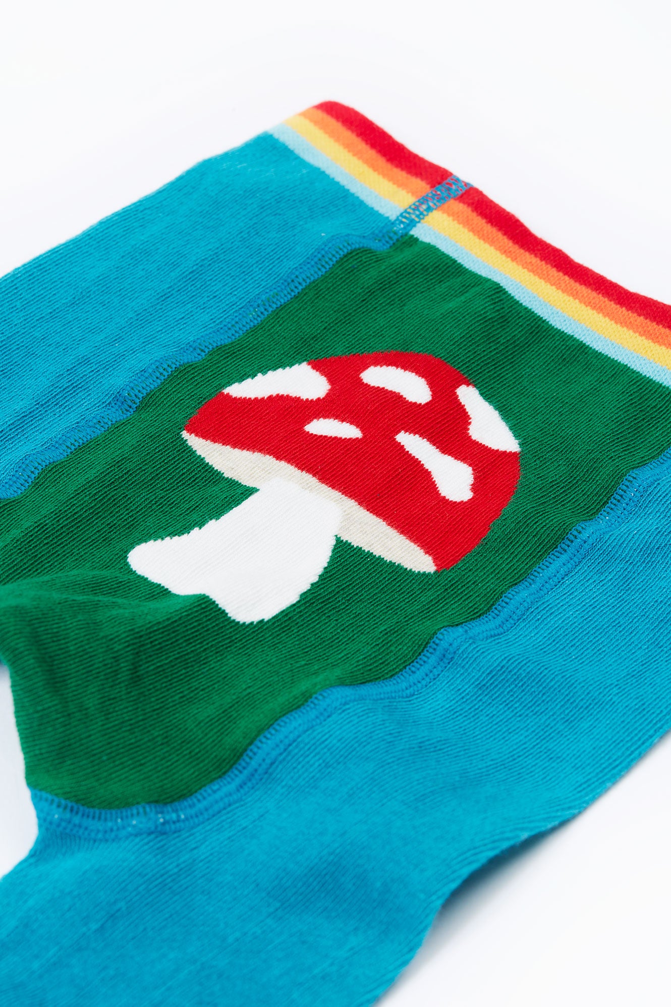 Colorful organic cotton tights with a mushroom design on a white background
