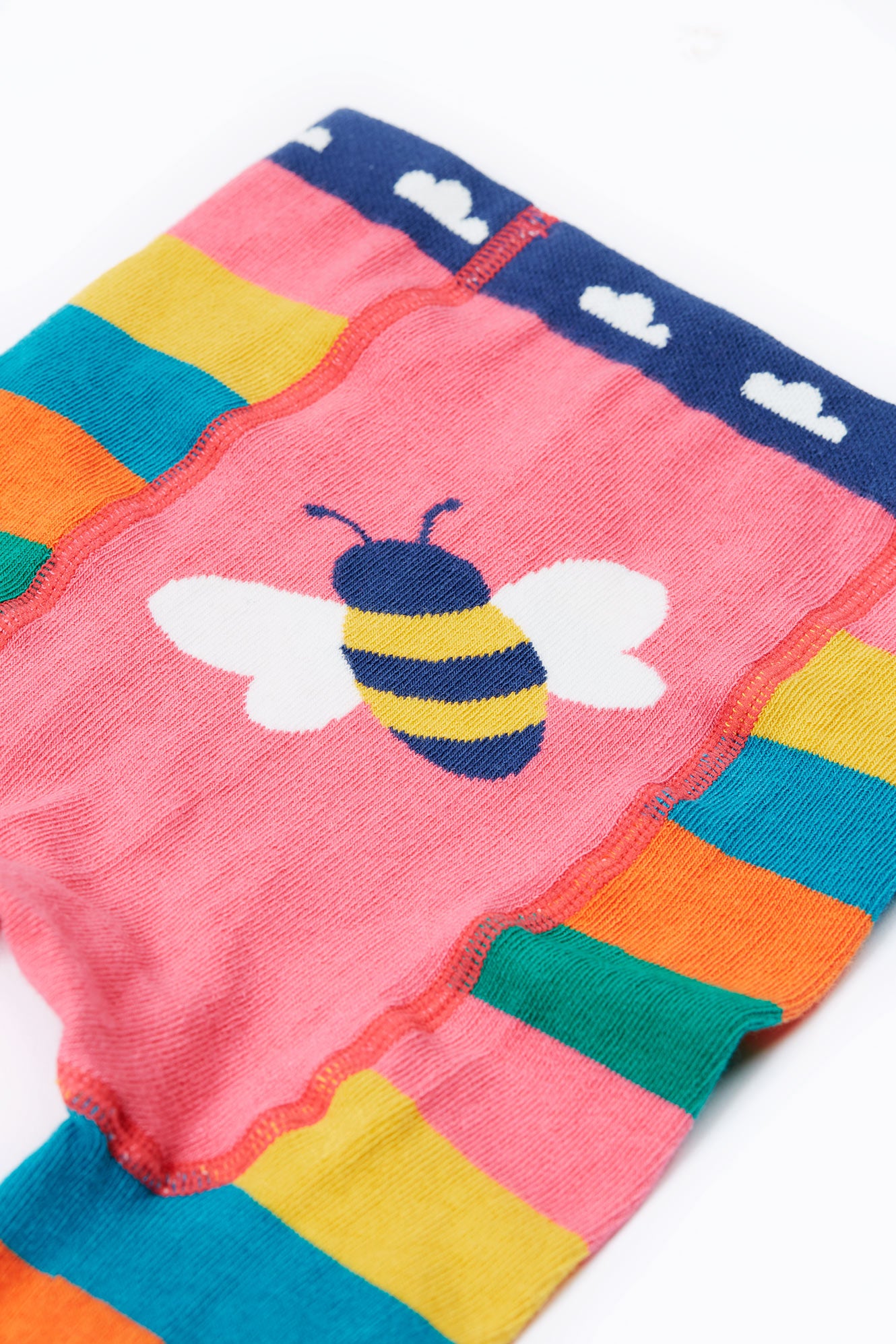 Colorful baby organic cotton leggings with a bee design on a white background