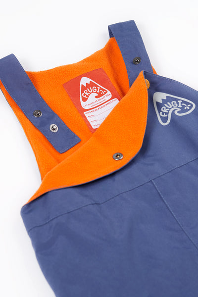Adjustable snap shoulder straps on Frugi waterproof dungarees, made from recycled polyester with orange fleece lining.