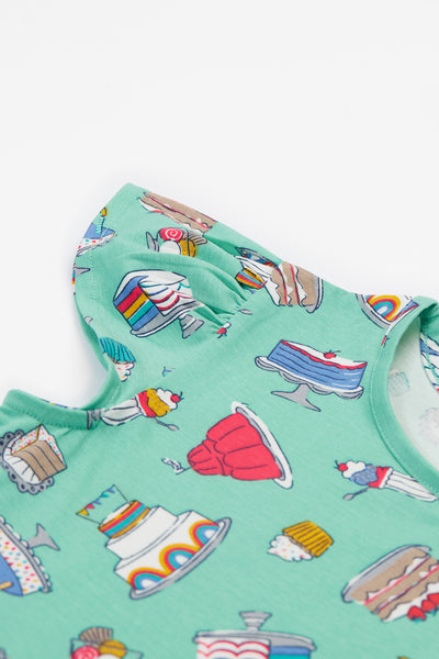 Close-up of the organic cotton fabric with fun, colourful baking illustrations.