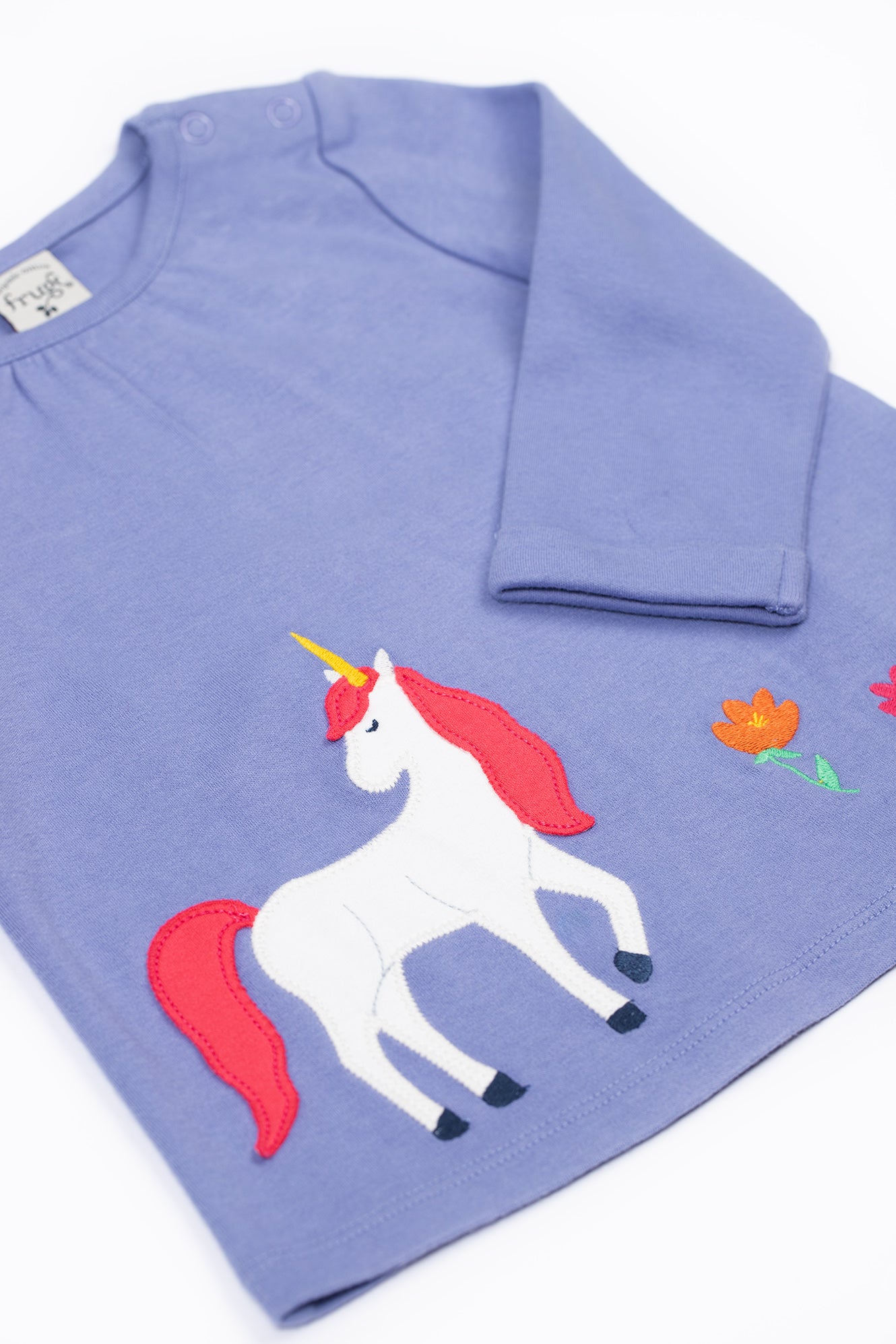 Blue kids organic cotton shirt with a unicorn design on a white background