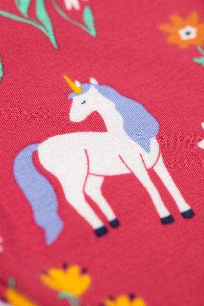 Unicorn design on a red organic cotton fabric background with flowers