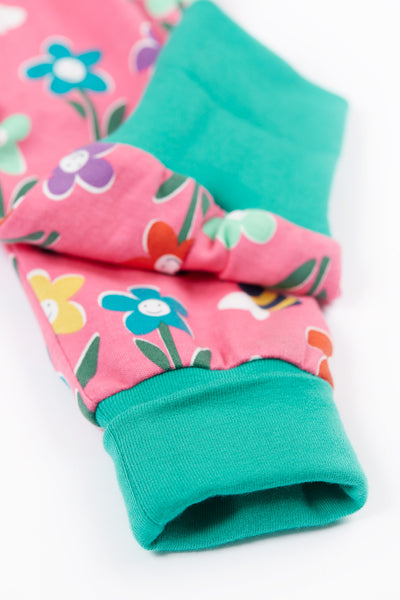 Close up of green leg cuffs on Frugi organic cotton trousers