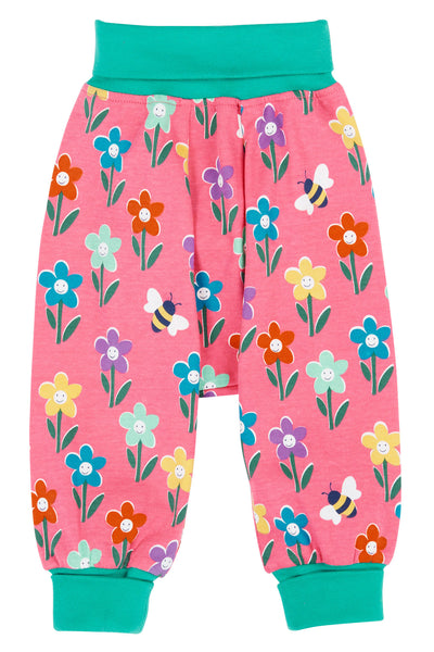 Frugi pink organic cotton trousers with green trim and multicolour flowers