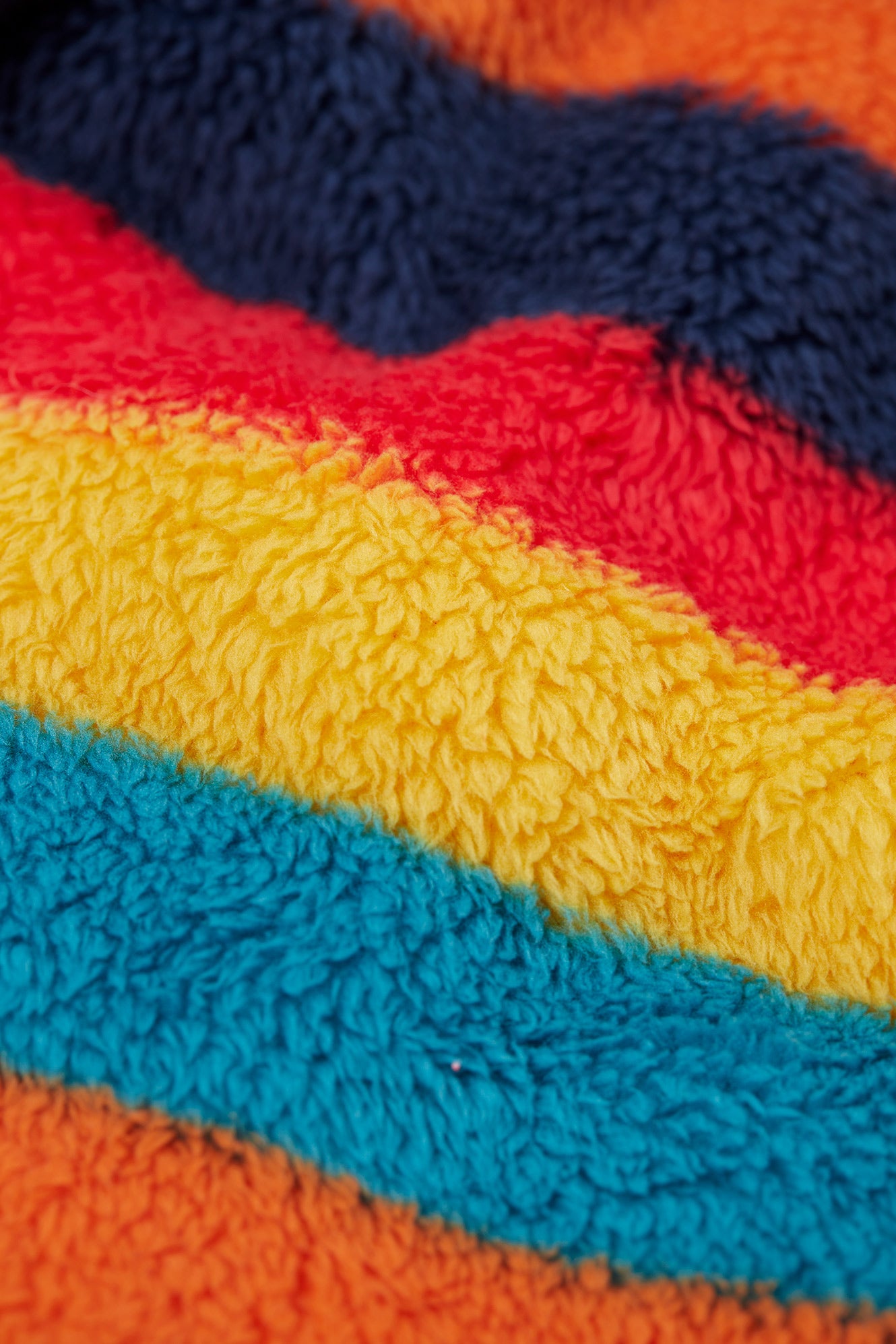 Close-up of colorful striped fabric with red, yellow, blue, and orange.