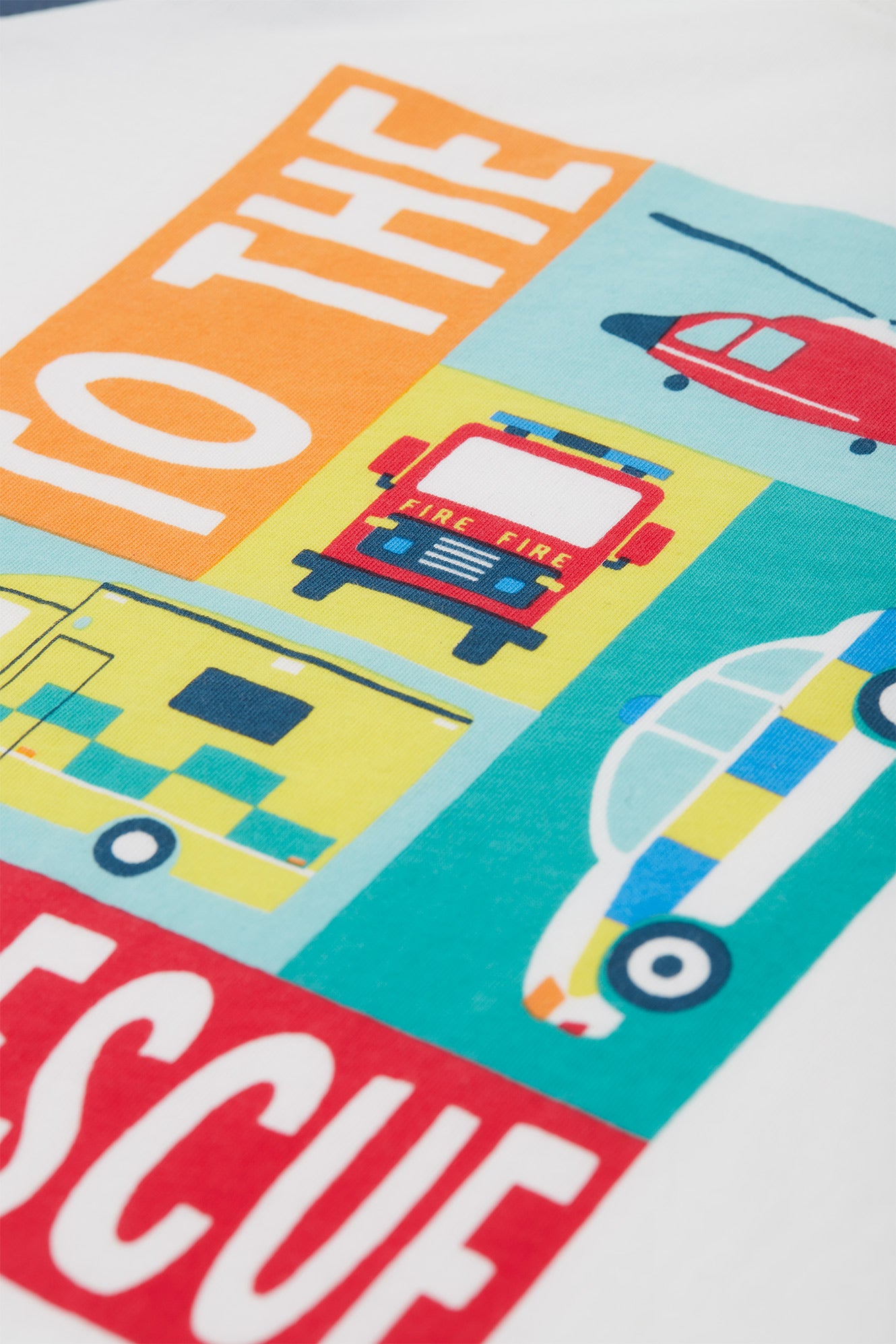 Close up of 'TO THE RESCUE' graphic on the Frugi Reid Raglan T-Shirt, showcasing illustrations of various rescue vehicles.