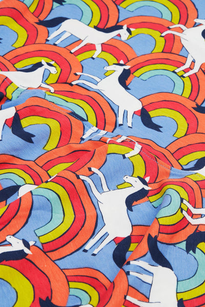 Close-up of the soft organic cotton jersey fabric with vibrant rainbows 
