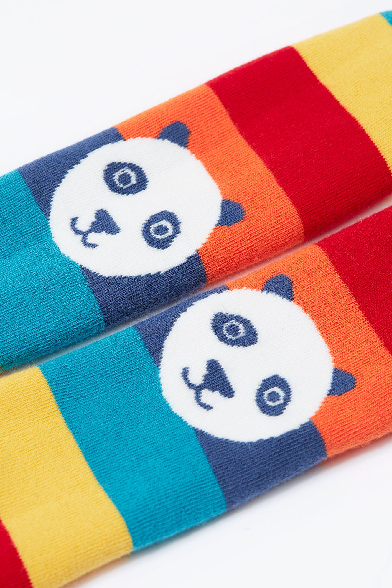 Colorful organic cotton tights with panda faces on a white background