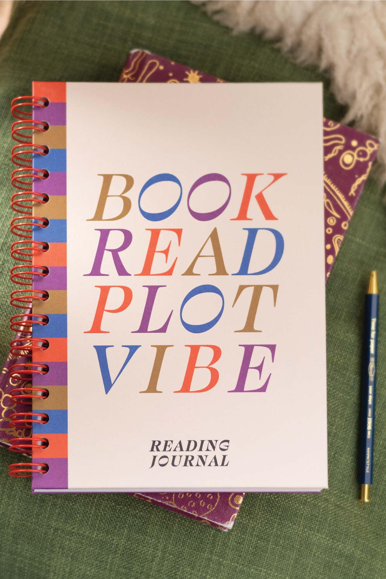 Notebook titled 'Book Read Plot Vibe' with colorful text on a green surface.
