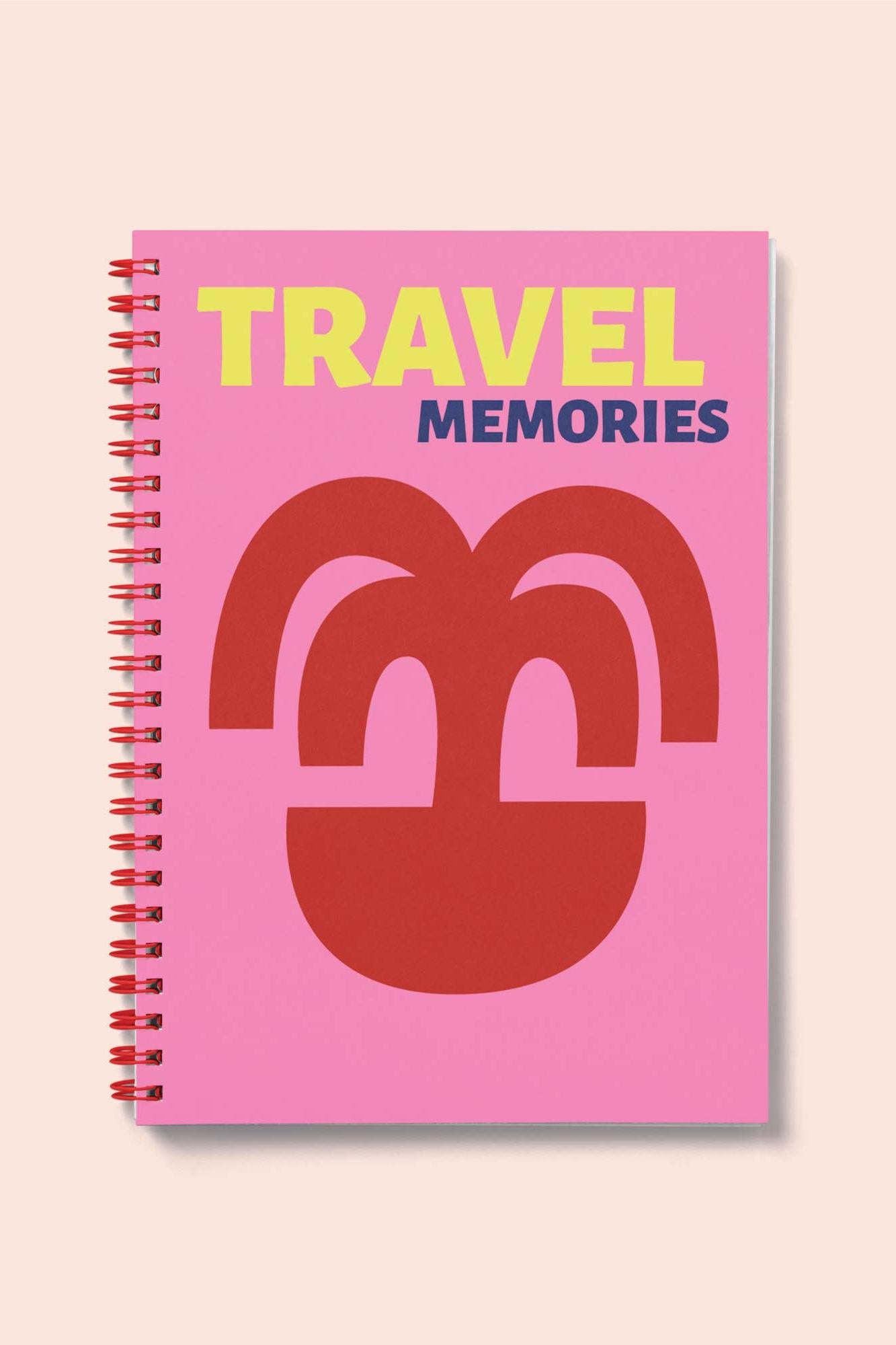 Notebook with 'Travel Memories' text and palm tree design on a pink cover